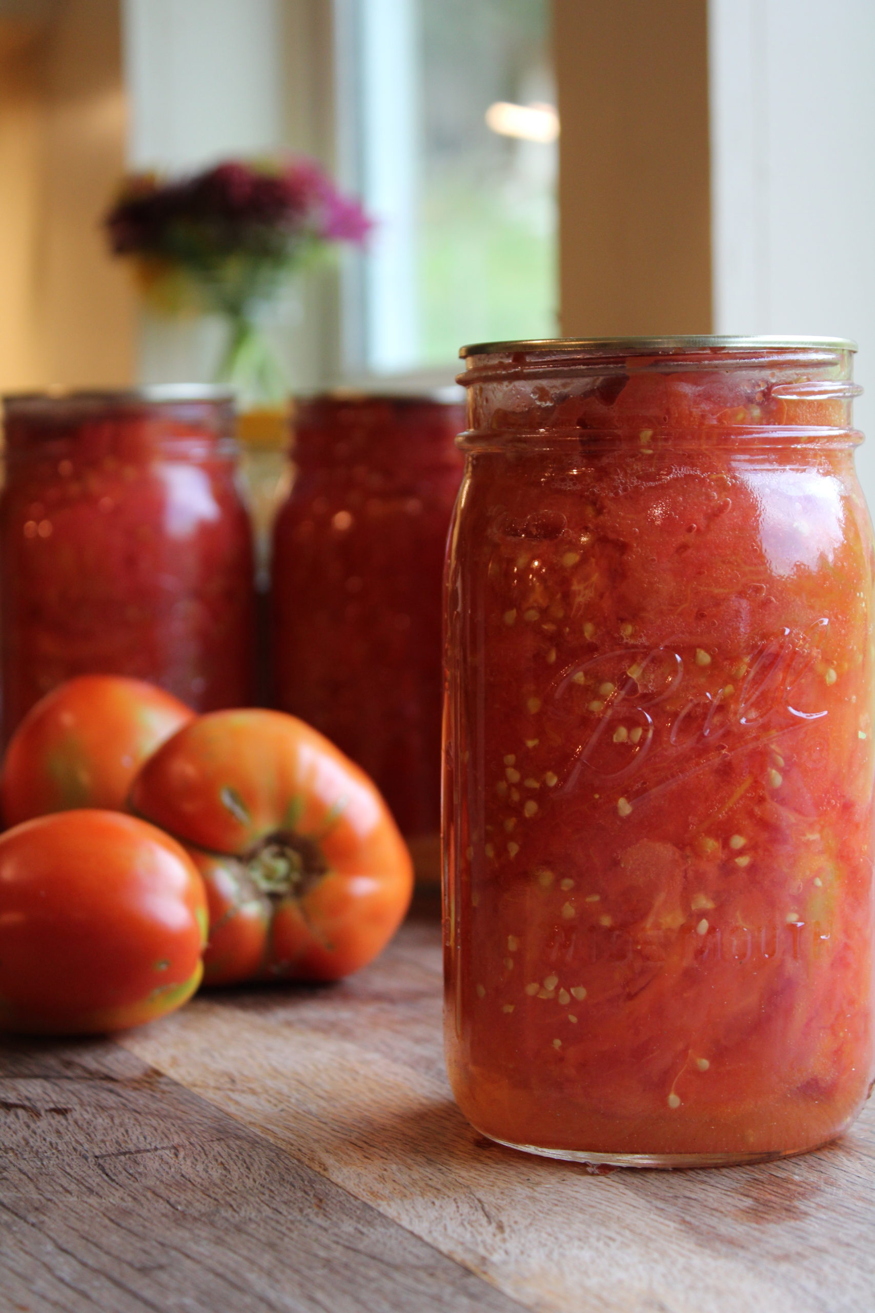 jar of canned tomatoes sitting on a counter