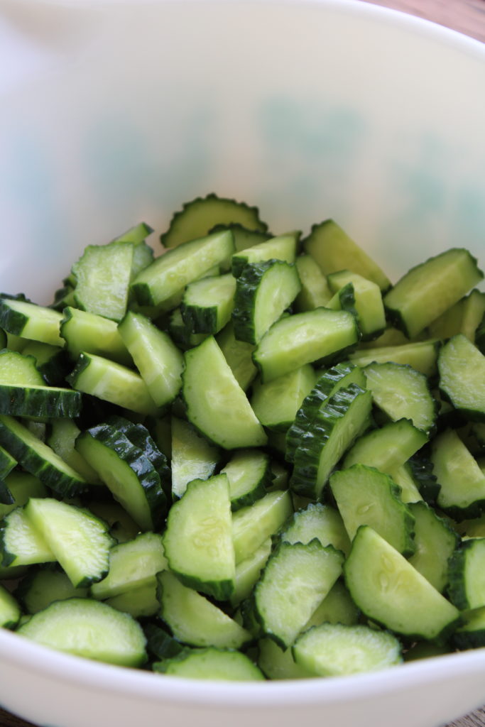 showing how to cut up cucumbers for cucumber and tomato salad