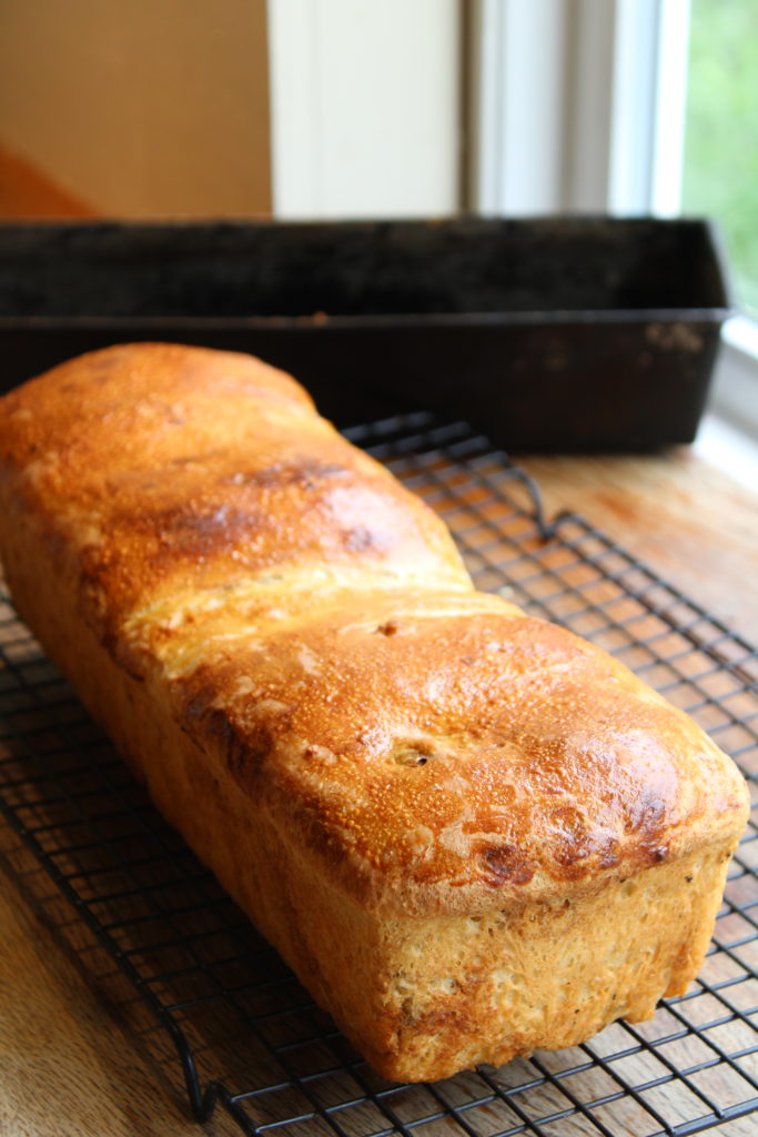 cinnamon raisin bread on a cooling rack