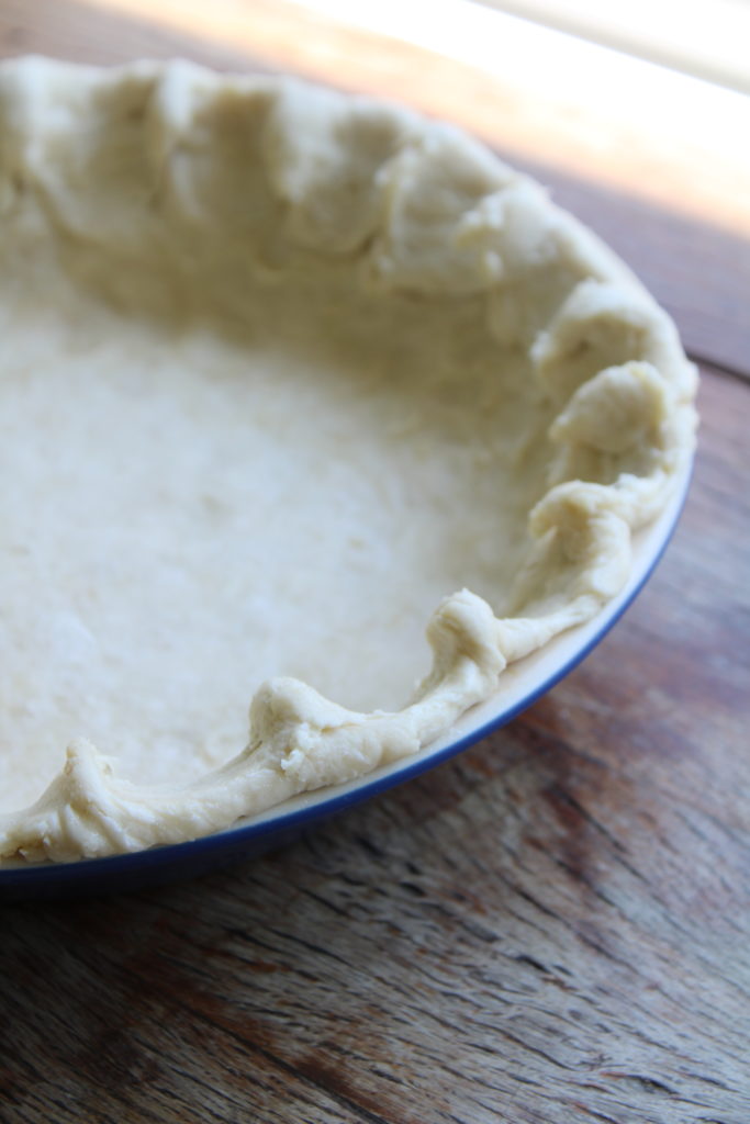 a flaky pie crust in a pie dish