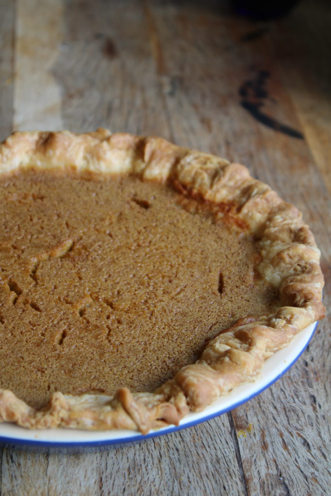 candy roaster pumpkin pie in a blue pie dish