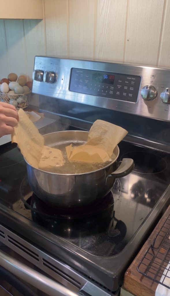 showing how to boil sourdough discard cinnamon raisin bagels 